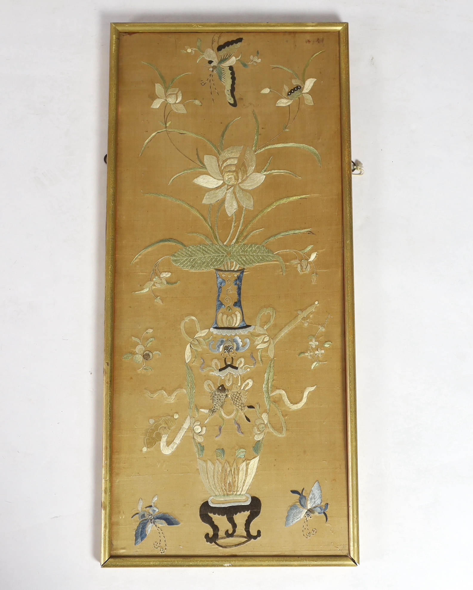 A framed 19th century Chinese silk embroidery of a vase of flowers and auspicious symbols, butterflies and fish, 36cm wide x 83cm high